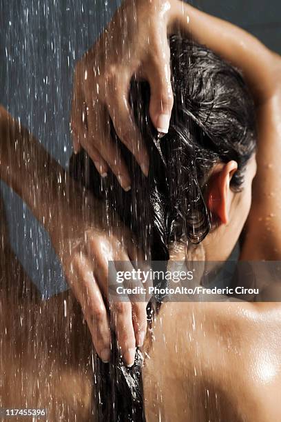 woman washing her hair in shower - wet hair back stock pictures, royalty-free photos & images