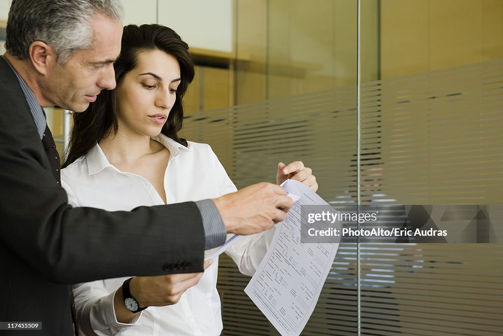 Executives reviewing document together