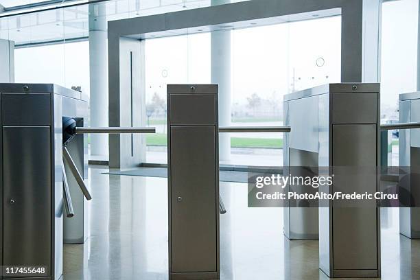 turnstiles in building lobby - barrier stock pictures, royalty-free photos & images