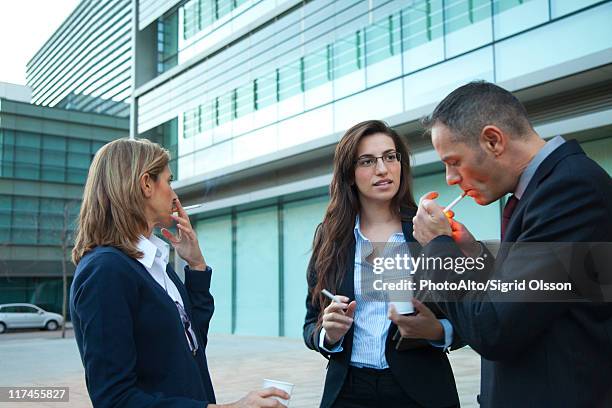 colleagues taking smoke break outdoors - tobacco workers stock pictures, royalty-free photos & images