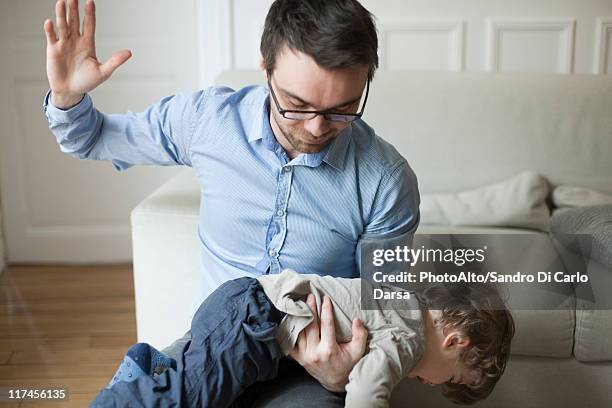 father disciplining toddler - tracht prügel stock-fotos und bilder