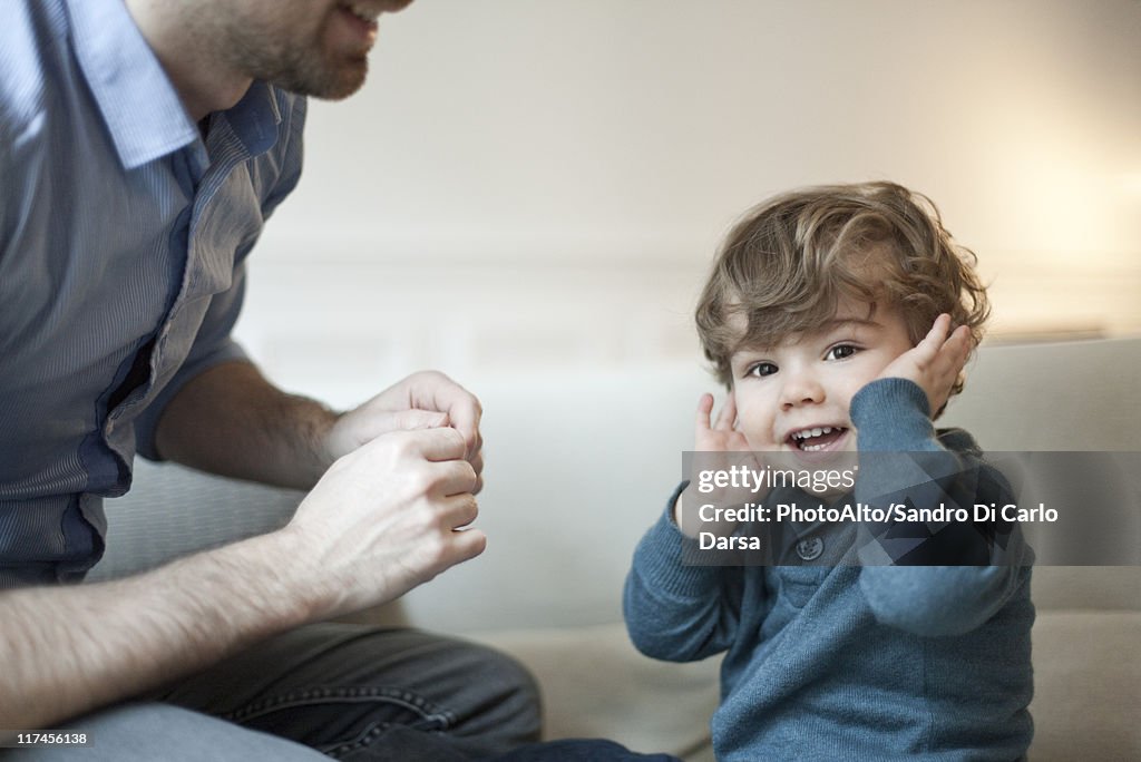 Toddler boy playing with father, portrait