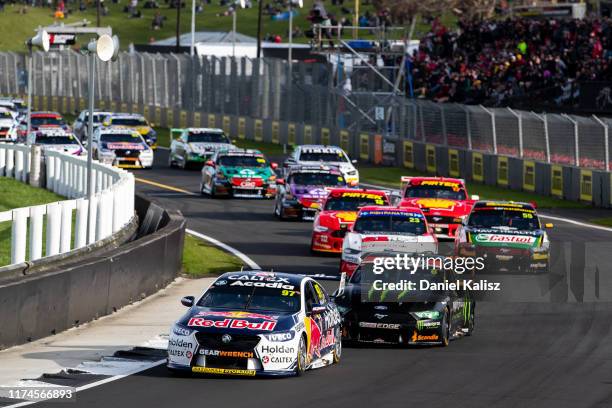 Shane van Gisbergen drives the Red Bull Holden Racing Team Holden Commodore ZB leads Cameron Waters drives the Monster Energy Racing Ford Mustang...