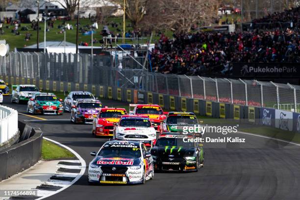 Shane van Gisbergen drives the Red Bull Holden Racing Team Holden Commodore ZB leads Cameron Waters drives the Monster Energy Racing Ford Mustang...