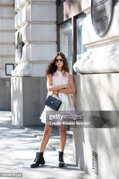 Hedvig Sagfjord Opshaug wears Givenchy sunglasses, Bora Aksu dress and Kurt Geiger boots and bag on September 13, 2019 in London, England.