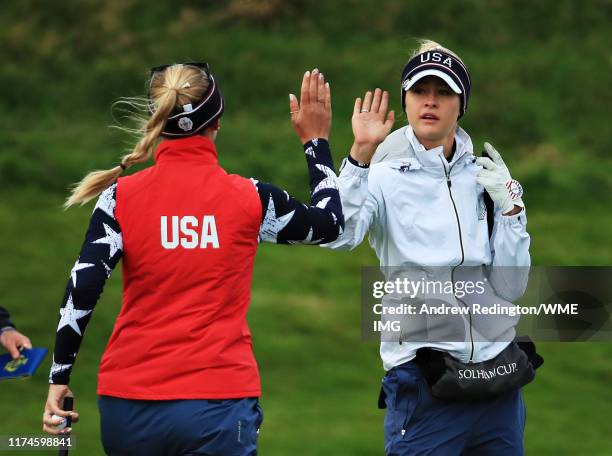 Jessica Korda and Nelly Korda of Team USA high five on the first green during Day 2 of the Solheim Cup at Gleneagles on September 14, 2019 in...