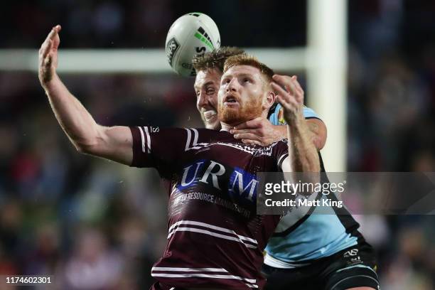 Brad Parker of the Sea Eagles is tackled high by Aaron Gray of the Sharks during the NRL Elimination Final match between the Manly Sea Eagles and the...