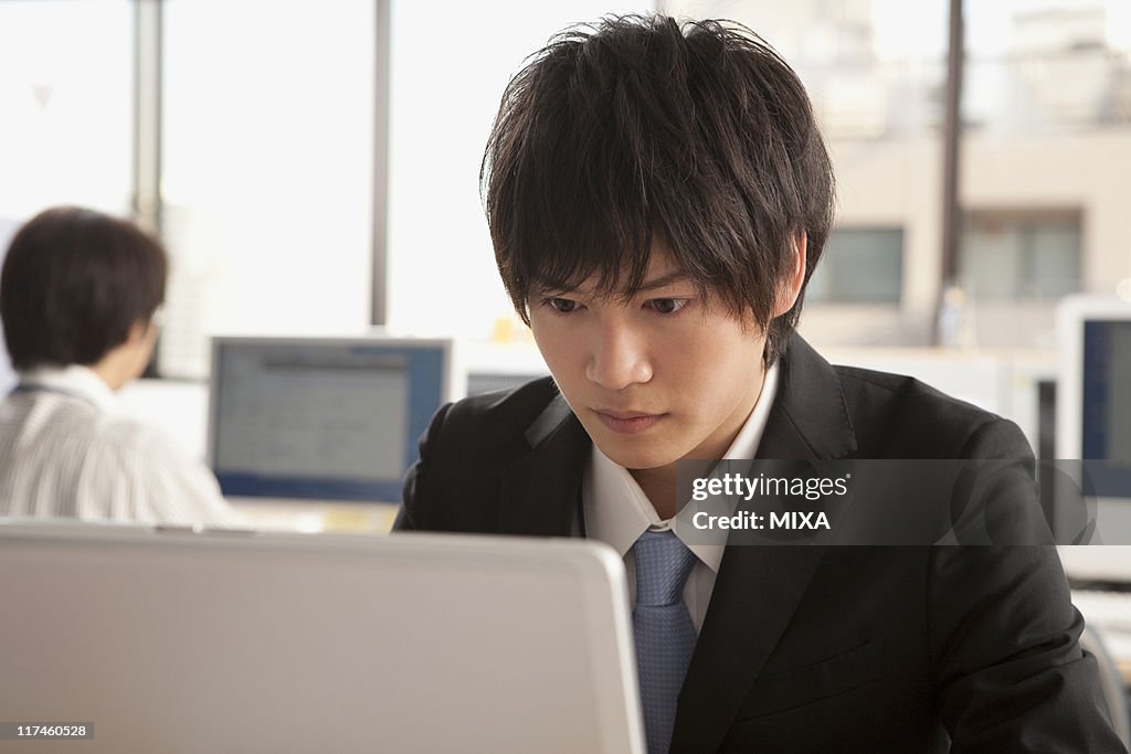 Young businessman using laptop