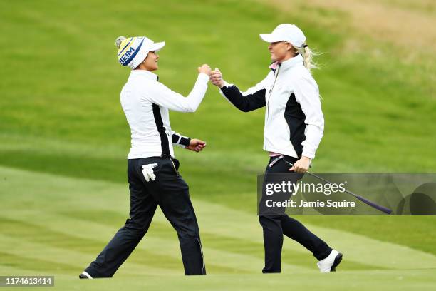 Charley Hull and Azahara Munoz of Team Europe react to winning their match on the fifteenth green during Day 2 of the Solheim Cup at Gleneagles on...