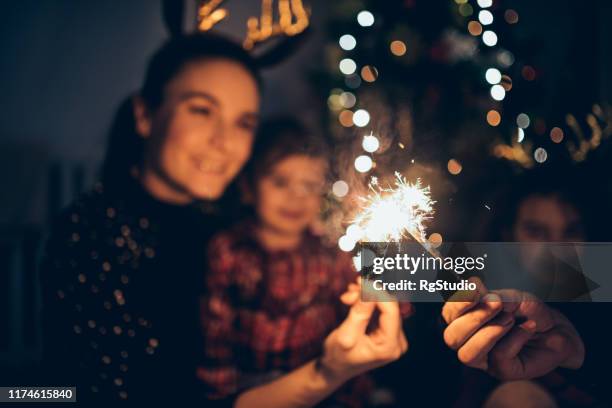 mother and daughters enjoying christmas - new year's eve children stock pictures, royalty-free photos & images