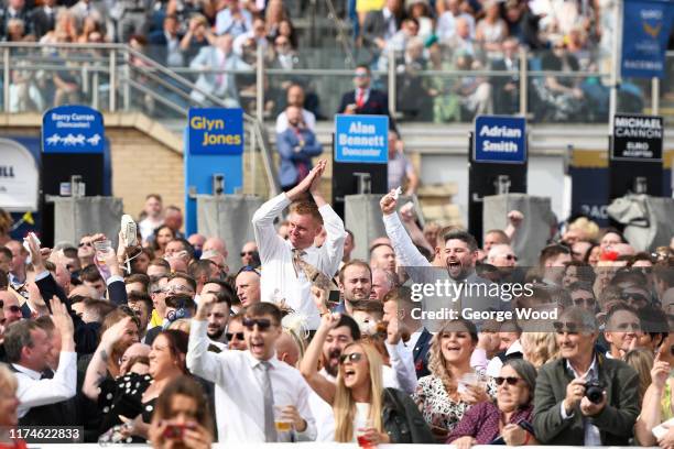 Spectators react during St Leger Day at Doncaster Racecourse on September 14, 2019 in Doncaster, England.