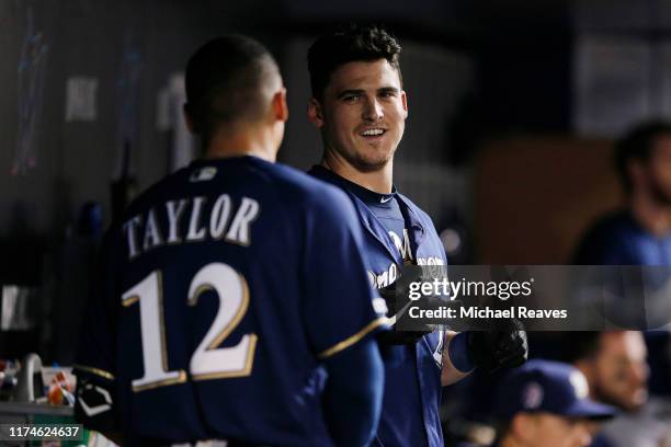 Tyler Austin of the Milwaukee Brewers talks with Tyrone Taylor against the Miami Marlins at Marlins Park on September 11, 2019 in Miami, Florida.