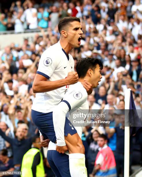 Heung-Min Son of Tottenham Hotspur celebrates with teammate Erik Lamela after scoring his team's first goal during the Premier League match between...