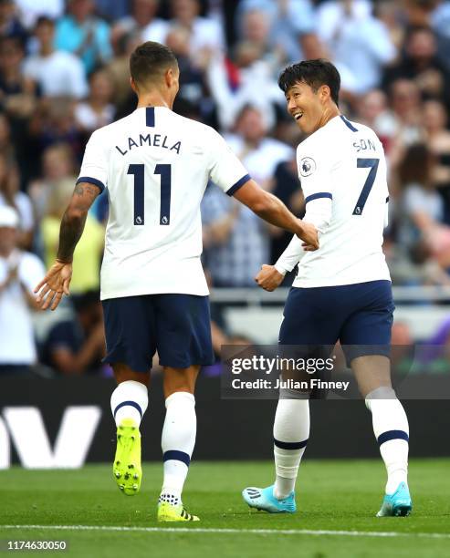 Heung-Min Son of Tottenham Hotspur celebrates after scoring his team's third goal with Erik Lamela of Tottenham Hotspur during the Premier League...