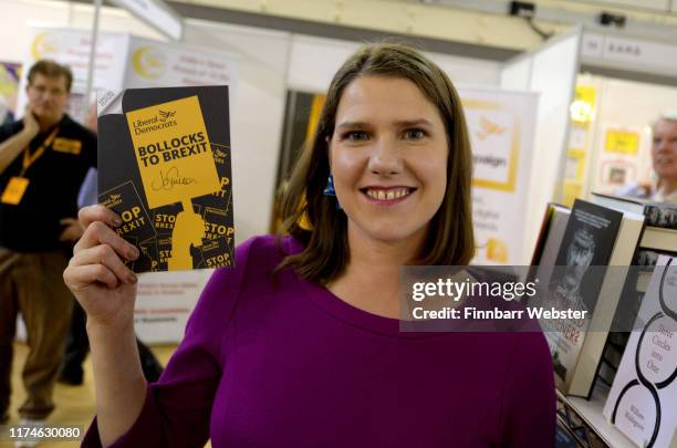 Liberal Democrat leader Jo Swinson signs their 'Bollocks to Bexit' manifesto as she tours the trade stands in the exhibition hall at the Liberal...