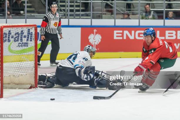 Goalkeeper Marek Schwarz of Bili Tygri Liberec and Thomas Jordan T.J. Trevelyan of Augsburger Panther battle for the ball during match between...