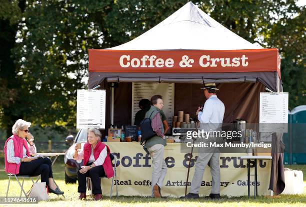 Princess Anne, Princess Royal and husband Sir Tim Laurence queue up at at pop-up coffee shop as they attend day 2 of the Whatley Manor Gatcombe...