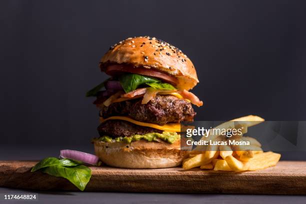 big cheese burger with fries - burgers stock-fotos und bilder