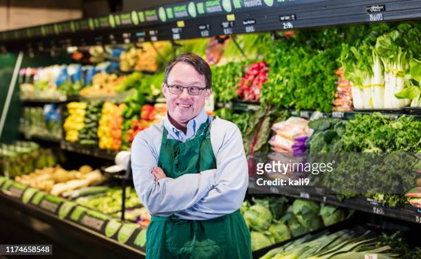 mann mit down-syndrom arbeitet im supermarkt - persons with disabilities stock-fotos und bilder
