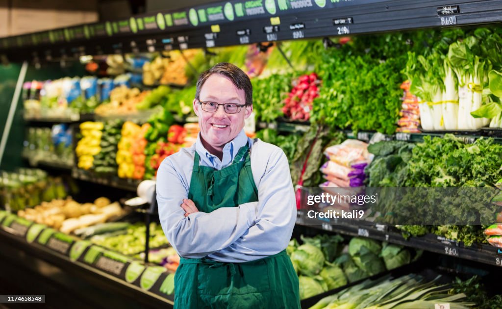 Man with down syndrome working in supermarket