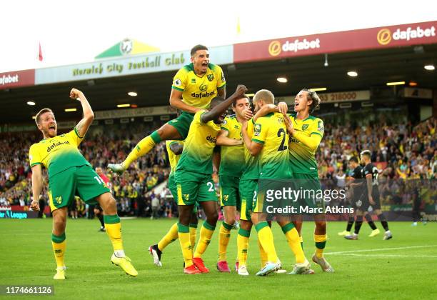 Teemu Pukki of Norwich City celebrates with teammates after scoring his team's third goal during the Premier League match between Norwich City and...