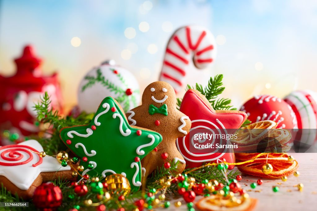 Festive concept with Christmas gingerbread in the shape of a star, fir branches and winter spices.