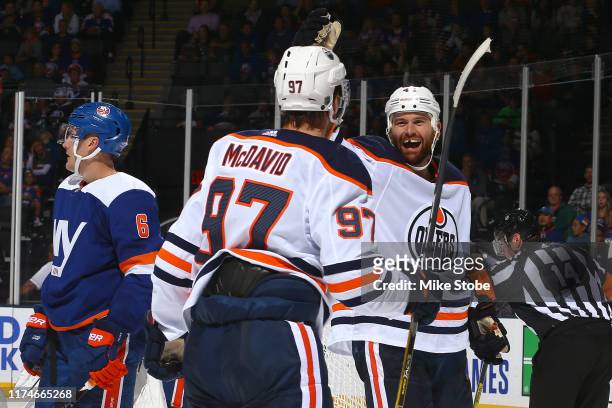 Zack Kassian of the Edmonton Oilers is congratulated by his teammate Connor McDavid after scoring a goal against the New York Islanders during the...