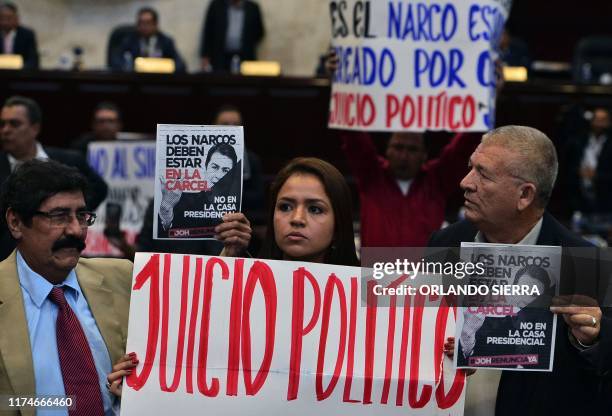 Opposition deputies, including the daughter of slain environmental activist and indigenous leader Berta Caceres, Olivia Zuniga , demonstrate to...