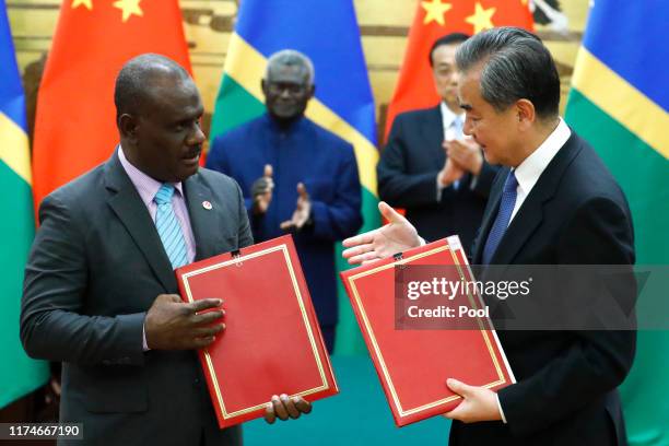 Chinese State Councillor and Foreign Minister Wang Yi and Solomon Islands Foreign Minister Jeremiah Manele attend a signing ceremony at the Great...