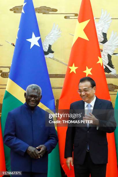 Solomon Islands Prime Minister Manasseh Sogavare and Chinese Premier Li Keqiang attend a signing ceremony at the Great Hall of the People in Beijing...