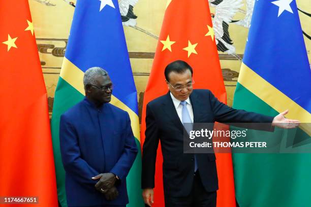 Solomon Islands Prime Minister Manasseh Sogavare and Chinese Premier Li Keqiang attend a signing ceremony at the Great Hall of the People in Beijing...