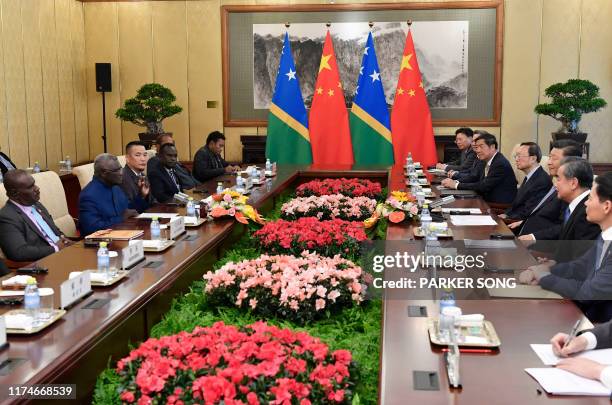 Solomon Islands Prime Minister Manasseh Sogavare speaks with Chinese President Xi Jinping during their meeting at the Diaoyutai State Guesthouse in...