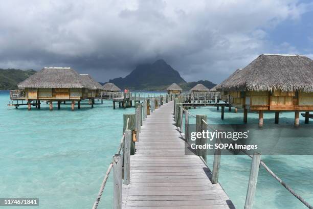 Over water bungalows in the aqua-centric luxury Bora Bora Pearl Beach Resort & Spa resort. Bora Bora is a volcanic island of French Polynesia, in the...