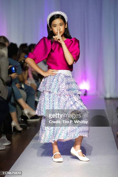Model walks the runway at the Melis Kapanpoglu Kids show on September 14, 2019 in London, United Kingdom.