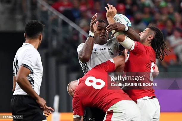 Fiji's lock Leone Nakarawa fights for the ball with Wales' number 8 Ross Moriarty and Wales' flanker Josh Navidi during the Japan 2019 Rugby World...