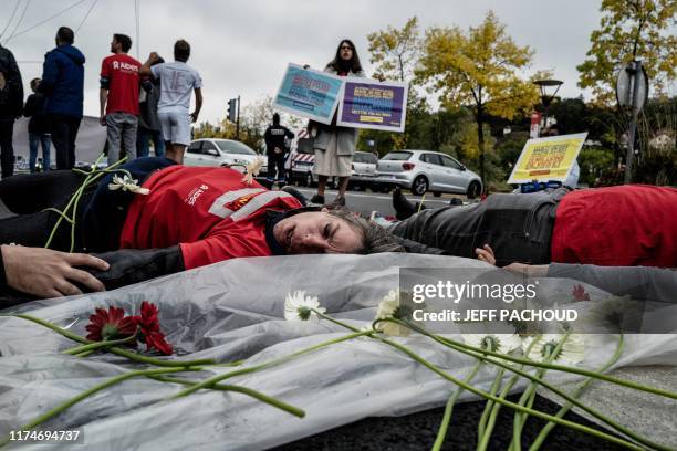 Members of French NGO Aides protest outside the venue of Sixth Replenishment Conference of the Global Fund to Fight AIDS, Tuberculosis and Malaria,...