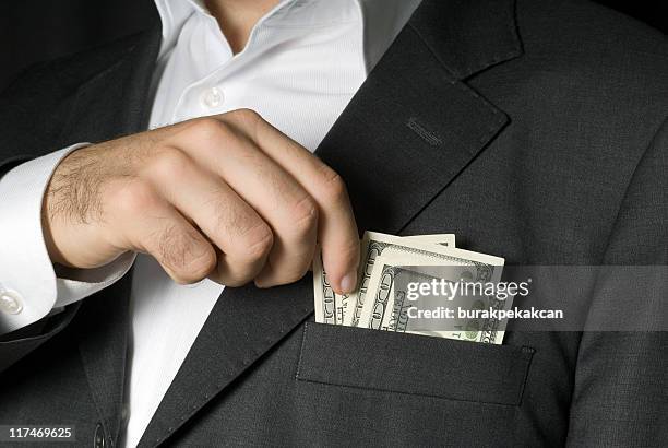 businessman holding hundred dollar notes in jacket pocket, close-up - white pocket stock pictures, royalty-free photos & images