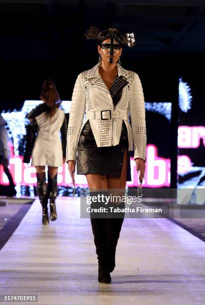 Model walks the runway for Michael Lombard at the House of iKons show at Hilton London Metropole on September 14, 2019 in London, England.