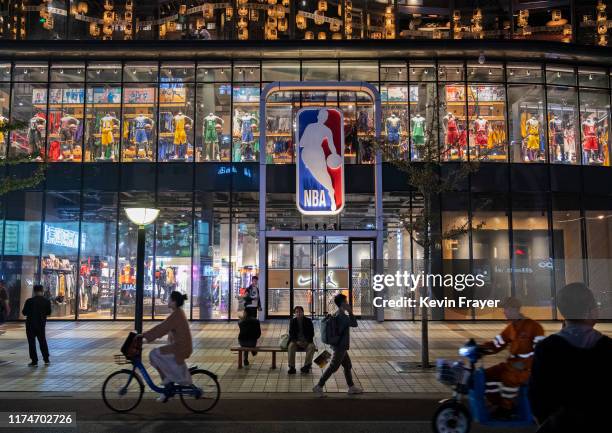 People walk by and sit outside the NBA flagship retail store on October 9, 2019 in Beijing, China. The NBA is trying to salvage its brand in China...