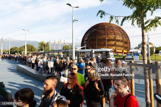 Visitors queue for registration early morning during the Open Days at the CERN particle physics research facility on September 14, 2019 in Meyrin,...