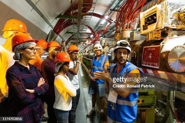 Scientist and guide talks to the visitors inside the tunnels at Point 6 of Cern, during the Open Days at the CERN particle physics research facility...