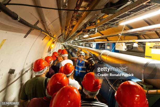 Visitors listen to the guide's explanations during the Open Days at the CERN particle physics research facility on September 14, 2019 in Meyrin,...