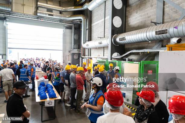 Visitors wait to go in the ALICE experiment and are briefed during the Open Days at the CERN particle physics research facility on September 14, 2019...