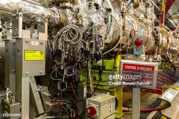 Signs of radiation and an emergency switch in one section of the Large Hadron Collider are seen during the Open Days at the CERN particle physics...