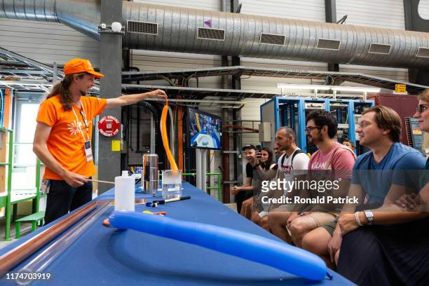 Scientists interact with visitors during the Open Days at the CERN particle physics research facility on September 14, 2019 in Meyrin, Switzerland....
