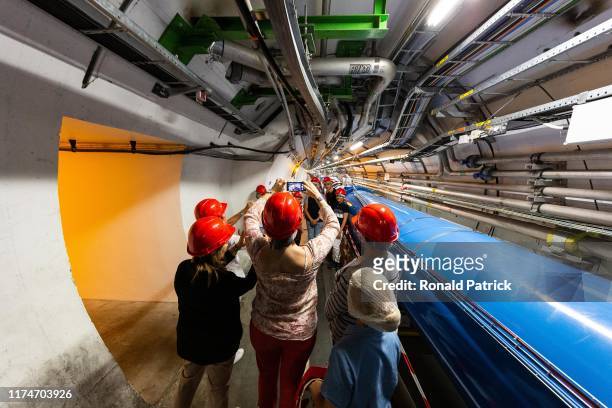 Visitors take pictures at the tunnels at the Point 4 section during the Open Days at the CERN particle physics research facility on September 14,...