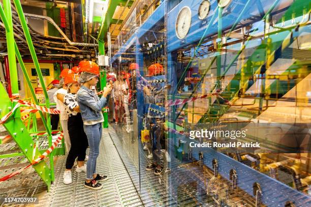 Visitors take pictures inside Point 4 during the Open Days at the CERN particle physics research facility on September 14, 2019 in Meyrin,...