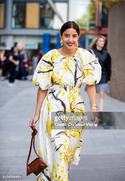 Bettina Looney is seen wearing yellow white dress with graphic print, brown bag outside Ports 1961 during London Fashion Week September 2019 on...