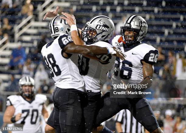 Brian Espanet of the New Hampshire Wildcats celebrates with teammate after making a catch for a touchdown in the first half against the FIU Golden...