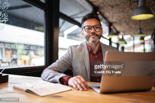 portrait of a business owner or businessman working in a restaurant - corporate business owner stock pictures, royalty-free photos & images